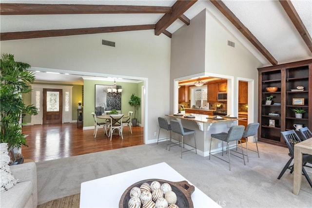 1915 Volk Ave, Long Beach, CA 90815 - living area featuring light carpet, beamed ceiling, a chandelier, and high vaulted ceiling