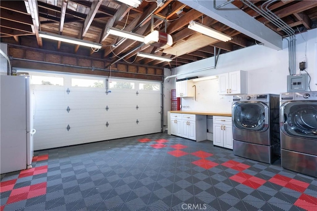 1915 Volk Ave, Long Beach, CA 90815 - washroom featuring cabinet space, washer and clothes dryer, dark floors, and a garage