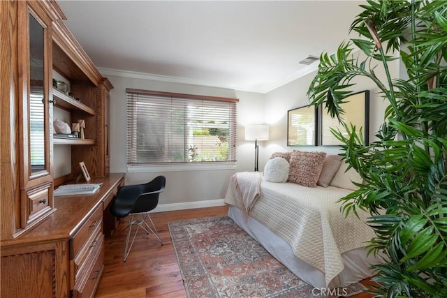 1915 Volk Ave, Long Beach, CA 90815 - bedroom featuring built in desk, wood finished floors, and crown molding