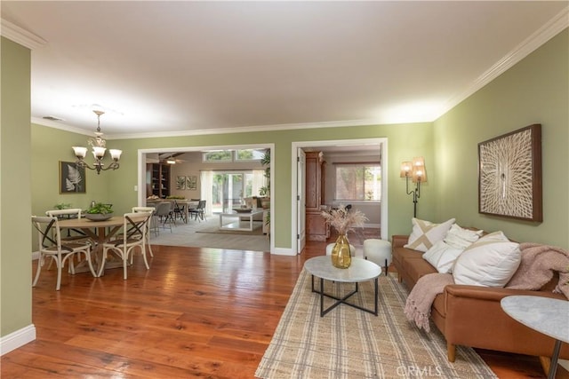 1915 Volk Ave, Long Beach, CA 90815 - living room with healthy amount of natural light, a chandelier, wood finished floors, and ornamental molding