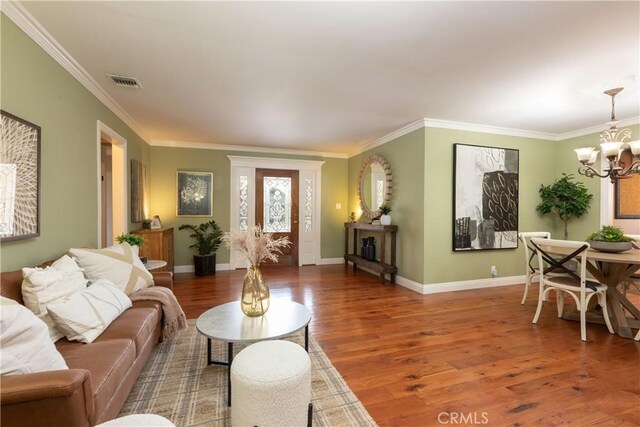 1915 Volk Ave, Long Beach, CA 90815 - living area featuring wood finished floors, a chandelier, and ornamental molding