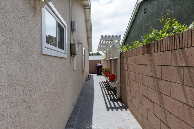1915 Volk Ave, Long Beach, CA 90815 - view of home's exterior featuring stucco siding, a pergola, and a patio area