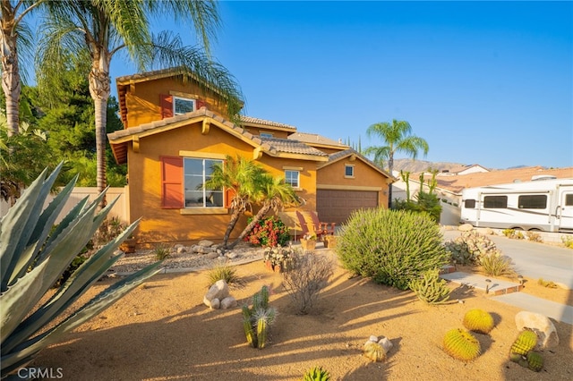 30050 Cabo Del Oeste, Highland, CA 92346 - mediterranean / spanish home with stucco siding, a tiled roof, and an attached garage