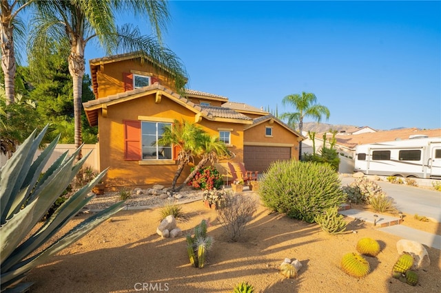 30050 Cabo Del Oeste, Highland, CA 92346 - mediterranean / spanish house featuring stucco siding, a tiled roof, and an attached garage