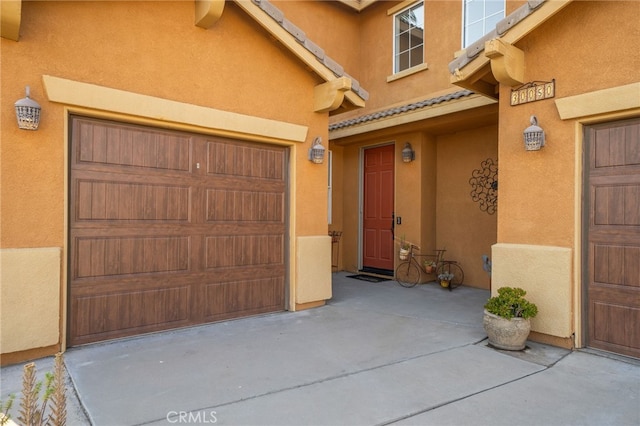 30050 Cabo Del Oeste, Highland, CA 92346 - entrance to property with a garage, stucco siding, and a tile roof