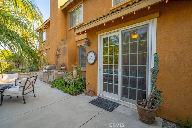 30050 Cabo Del Oeste, Highland, CA 92346 - doorway to property featuring an outdoor kitchen, stucco siding, a patio area, and a tiled roof