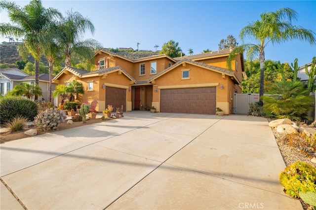 30050 Cabo Del Oeste, Highland, CA 92346 - view of front of house featuring a gate, stucco siding, an attached garage, and concrete driveway