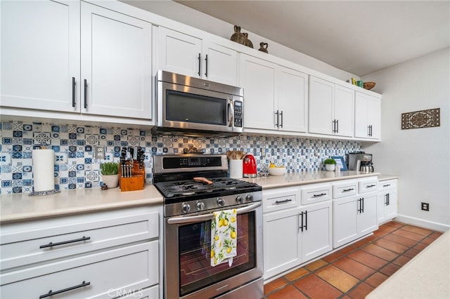 30050 Cabo Del Oeste, Highland, CA 92346 - kitchen featuring appliances with stainless steel finishes, backsplash, light countertops, white cabinetry, and dark tile patterned floors