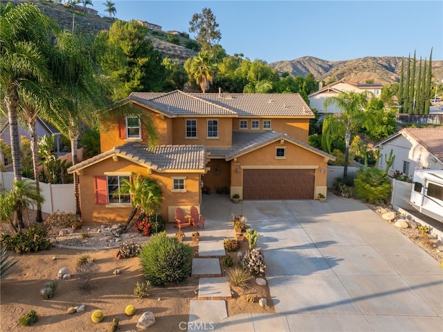 30050 Cabo Del Oeste, Highland, CA 92346 - mediterranean / spanish-style home featuring a tiled roof, driveway, stucco siding, a mountain view, and an attached garage