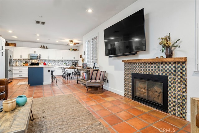 30050 Cabo Del Oeste, Highland, CA 92346 - living room featuring a tiled fireplace, light tile patterned flooring, recessed lighting, and a ceiling fan
