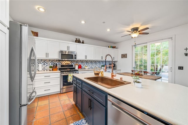 30050 Cabo Del Oeste, Highland, CA 92346 - kitchen featuring stainless steel appliances, white cabinets, light countertops, decorative backsplash, and ceiling fan