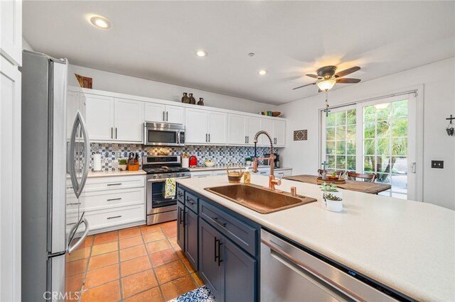 30050 Cabo Del Oeste, Highland, CA 92346 - kitchen with stainless steel appliances, white cabinetry, light countertops, decorative backsplash, and recessed lighting
