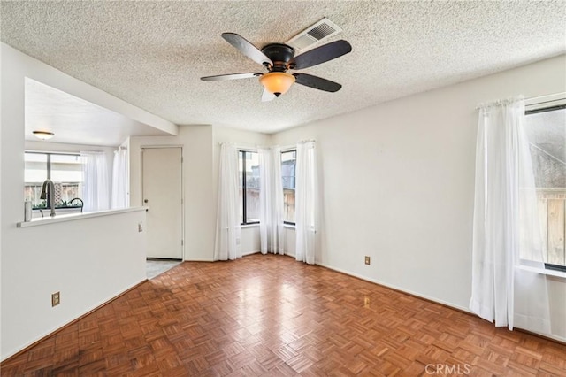 1497 Ruby Dr, Perris, CA 92571 - spare room featuring a ceiling fan, plenty of natural light, and a textured ceiling