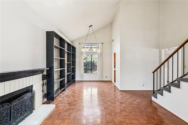 1497 Ruby Dr, Perris, CA 92571 - unfurnished living room featuring stairs, a brick fireplace, and high vaulted ceiling