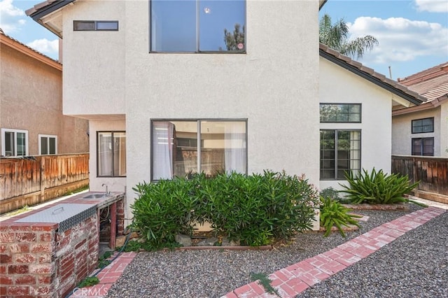 1497 Ruby Dr, Perris, CA 92571 - rear view of property featuring stucco siding and a sink