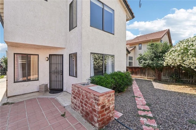 1497 Ruby Dr, Perris, CA 92571 - back of property featuring stucco siding, a patio, and a fenced backyard
