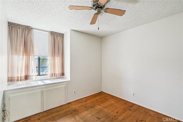 1497 Ruby Dr, Perris, CA 92571 - empty room featuring hardwood / wood-style flooring, a textured ceiling, and a ceiling fan