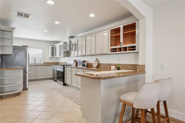 22832 Larkin St, Lake Forest, CA 92630 - kitchen with appliances with stainless steel finishes, open shelves, a peninsula, wall chimney exhaust hood, and a breakfast bar area
