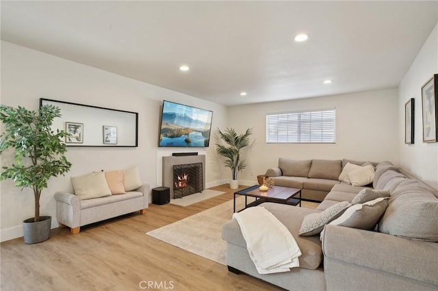22832 Larkin St, Lake Forest, CA 92630 - living area with light wood-type flooring, a fireplace with flush hearth, and recessed lighting