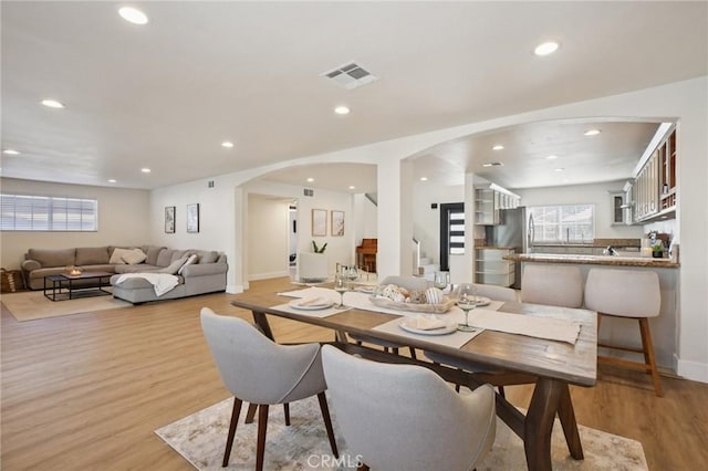 22832 Larkin St, Lake Forest, CA 92630 - dining room with arched walkways, light wood-style flooring, and recessed lighting