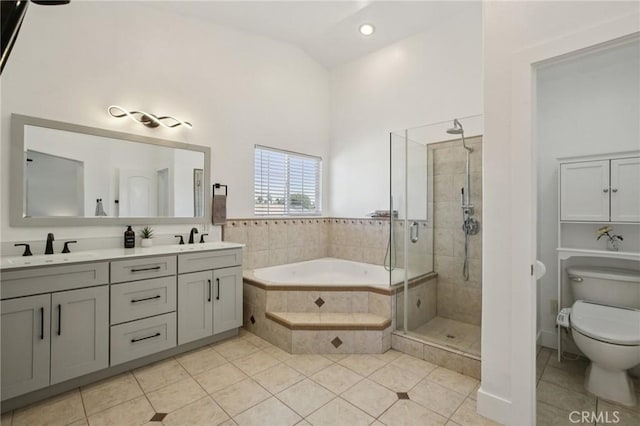 22832 Larkin St, Lake Forest, CA 92630 - full bathroom with tile patterned floors, a bath, double vanity, a shower stall, and vaulted ceiling