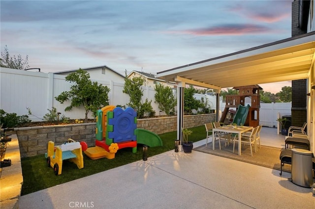 22832 Larkin St, Lake Forest, CA 92630 - patio terrace at dusk featuring a playground, a patio area, a fenced backyard, and outdoor dining space