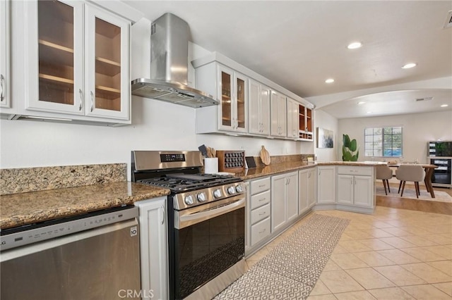 22832 Larkin St, Lake Forest, CA 92630 - kitchen with wall chimney exhaust hood, stainless steel appliances, a peninsula, recessed lighting, and light tile patterned floors