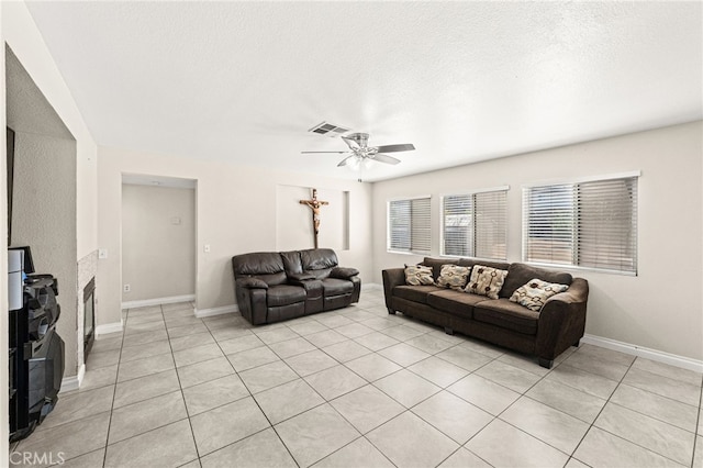 25969 Magnifica Ct, Moreno Valley, CA 92551 - living area featuring ceiling fan, light tile patterned floors, a textured ceiling, and a fireplace