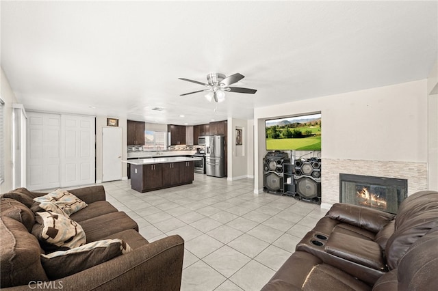 25969 Magnifica Ct, Moreno Valley, CA 92551 - living room featuring light tile patterned flooring, ceiling fan, and a stone fireplace