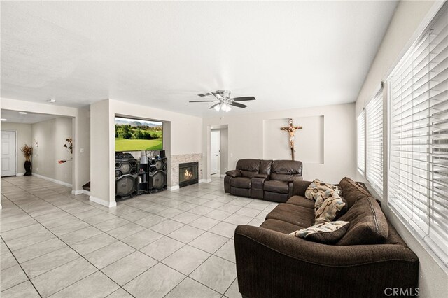 25969 Magnifica Ct, Moreno Valley, CA 92551 - living room with light tile patterned floors, healthy amount of natural light, a ceiling fan, and a fireplace
