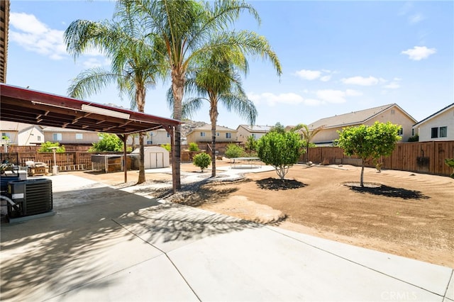 25969 Magnifica Ct, Moreno Valley, CA 92551 - view of yard featuring a storage unit, a patio area, and a residential view