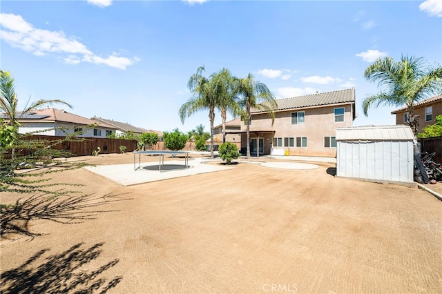 25969 Magnifica Ct, Moreno Valley, CA 92551 - rear view of property featuring a storage shed, stucco siding, a trampoline, and a patio