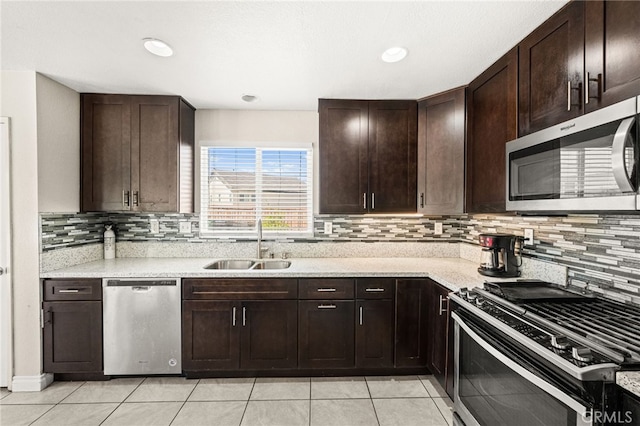 25969 Magnifica Ct, Moreno Valley, CA 92551 - kitchen featuring appliances with stainless steel finishes, light tile patterned floors, dark brown cabinetry, tasteful backsplash, and recessed lighting