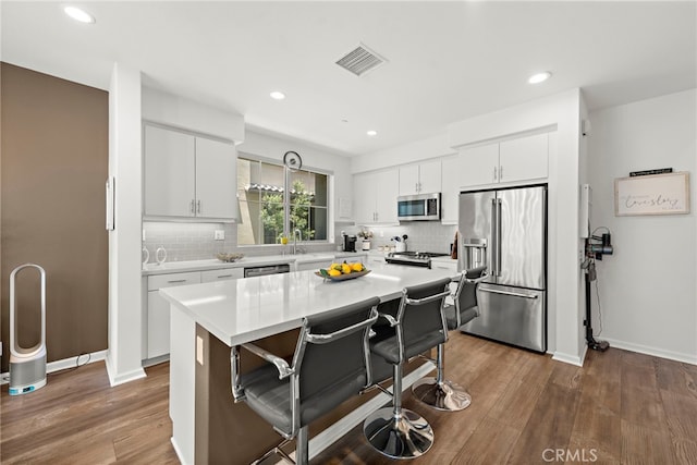 527 S Motif St, Anaheim, CA 92805 - kitchen featuring stainless steel appliances, decorative backsplash, a breakfast bar, light countertops, and recessed lighting