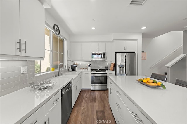 527 S Motif St, Anaheim, CA 92805 - kitchen featuring stainless steel appliances, backsplash, recessed lighting, light countertops, and dark wood-style flooring