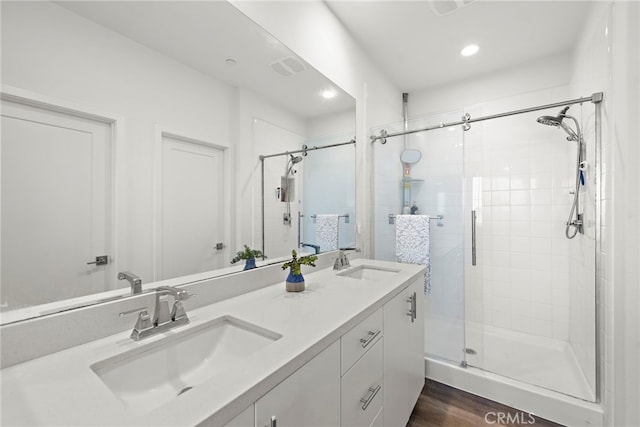 527 S Motif St, Anaheim, CA 92805 - bathroom featuring a stall shower, double vanity, recessed lighting, and wood finished floors