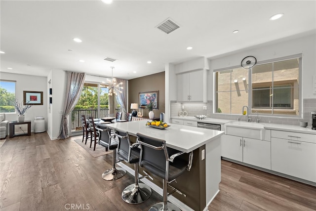 527 S Motif St, Anaheim, CA 92805 - kitchen featuring decorative backsplash, white cabinetry, plenty of natural light, and recessed lighting