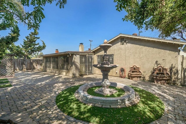 7384 Ballinger, San Diego, CA 92119 - rear view of property with stucco siding and a patio