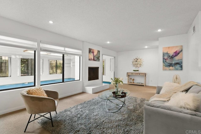 7384 Ballinger, San Diego, CA 92119 - living room featuring light carpet, recessed lighting, a textured ceiling, and a fireplace with raised hearth
