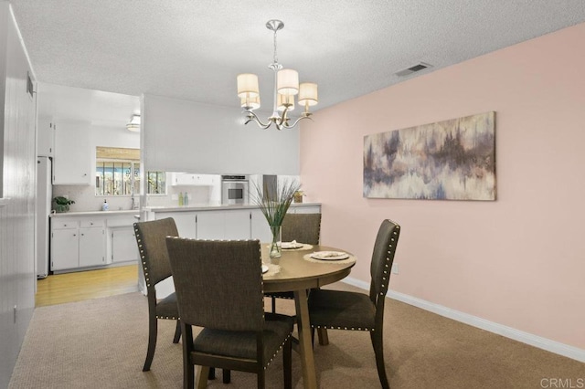 7384 Ballinger, San Diego, CA 92119 - dining room with a chandelier, light colored carpet, and a textured ceiling