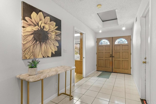 7384 Ballinger, San Diego, CA 92119 - entryway with a textured ceiling, light tile patterned floors, and a raised ceiling
