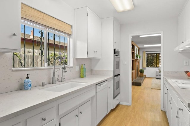 7384 Ballinger, San Diego, CA 92119 - kitchen with dishwasher, light countertops, light wood finished floors, and white cabinets
