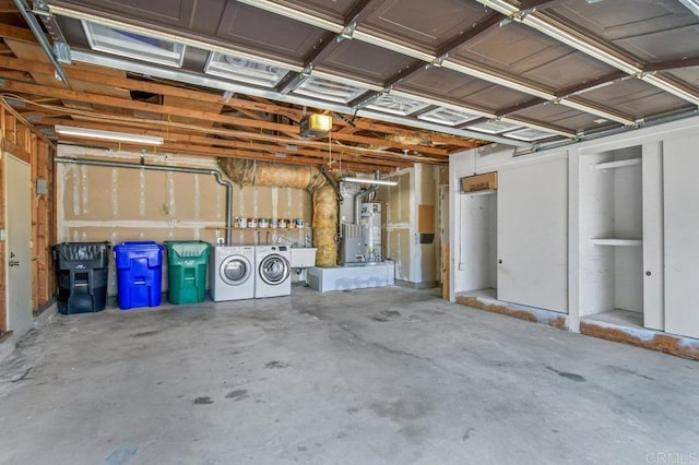 7384 Ballinger, San Diego, CA 92119 - garage featuring separate washer and dryer, heating unit, and strapped water heater