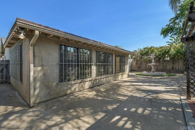 7384 Ballinger, San Diego, CA 92119 - view of home's exterior featuring a patio and stucco siding