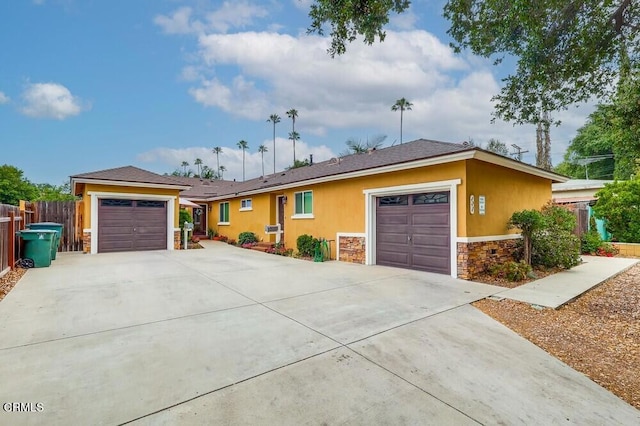  - ranch-style house with stone siding, stucco siding, and concrete driveway