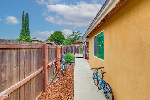  - view of home's exterior with stucco siding and a patio area