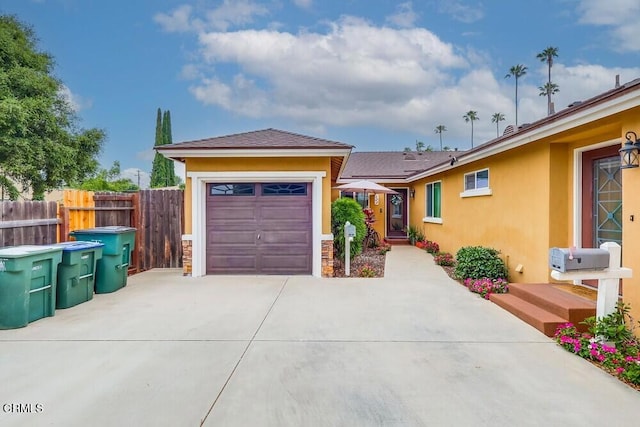  - ranch-style house with driveway, stucco siding, and an attached garage