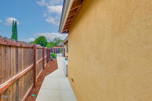  - view of property exterior with stucco siding and a patio