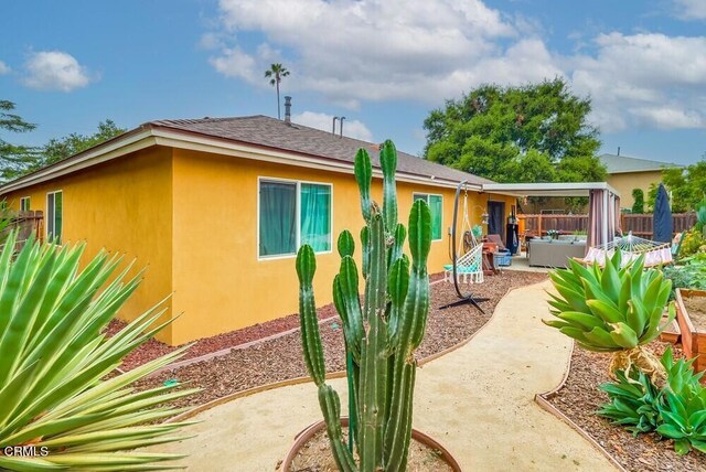  - rear view of property with a patio, stucco siding, and an outdoor living space