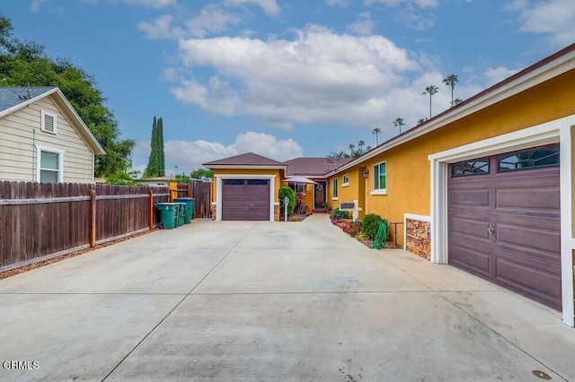  - view of side of property with stucco siding and a garage